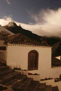 Houses against cloudy sky