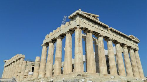 Low angle view of historical building against blue sky