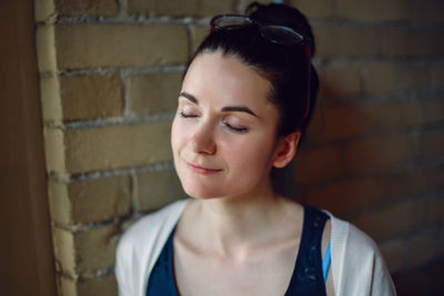 Portrait of woman against wall