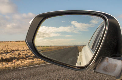 Reflection of road on side-view mirror
