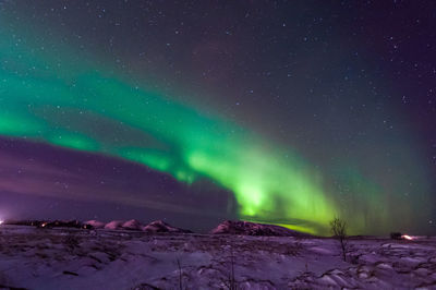 Scenic view of snowcapped mountains against sky at night