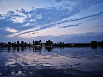 Scenic view of lake against sky at sunset