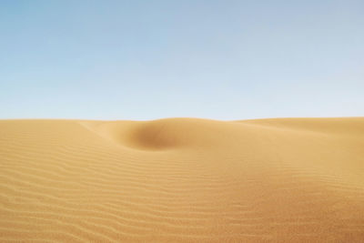 Scenic view of desert against clear sky