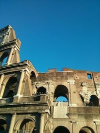 Low angle view of building against clear blue sky