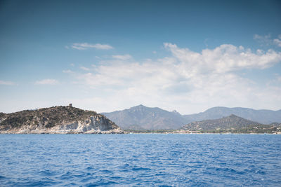 Scenic view of sea and mountains against sky
