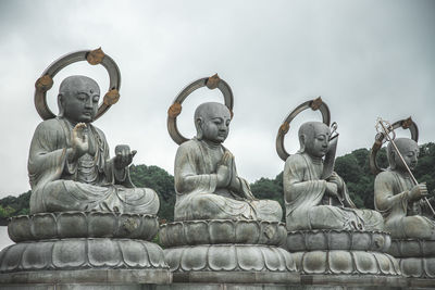 Low angle view of statue against sky