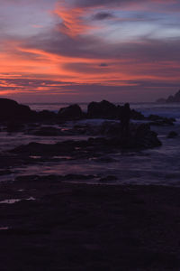 Scenic view of sea against orange sky