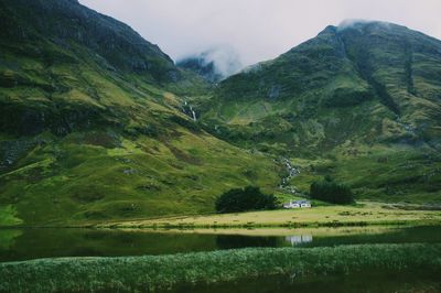 Scenic view of lake and mountains against sky