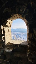 Buildings seen through arch window