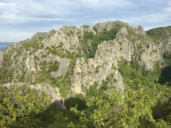 Panoramic view of rocks and trees against sky