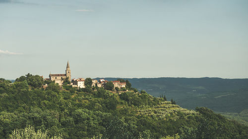 Panoramic view of buildings in countryside against sky