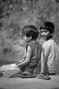 Boys sitting outdoors