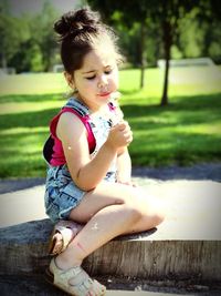 Portrait of cute girl sitting on grass