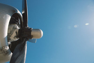 Cropped image of airplane against blue sky