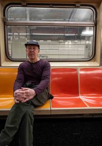 Portrait of young man sitting in train