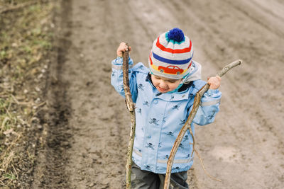 Full length of boy wearing hat standing on land