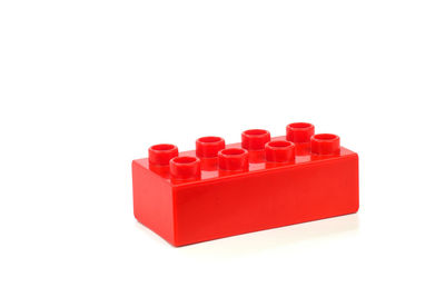 Close-up of red toy over white background