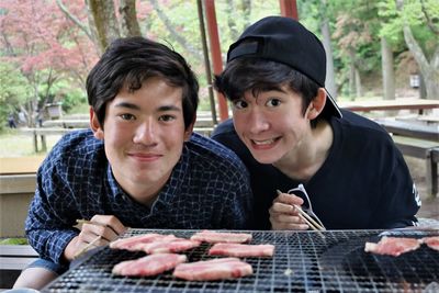 Portrait of a smiling young man holding food