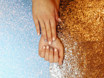 Cropped hands of woman with glitter