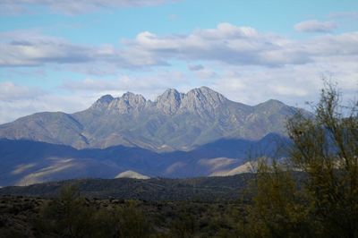 Scenic view of mountains against cloudy sky