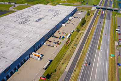 Aerial top view of the large logistics park with warehouse, loading hub with many semi-trailers .