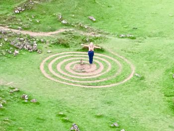 High angle view of woman standing on grass