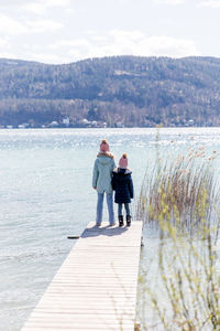 Rear view of woman walking on beach