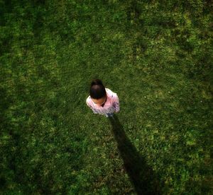 High angle view of woman standing on grassy field