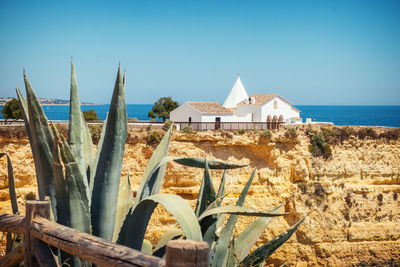 Built structure on beach against clear sky