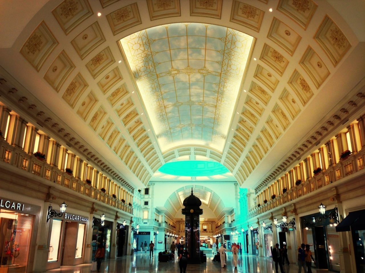 indoors, ceiling, architecture, built structure, lifestyles, large group of people, men, person, illuminated, leisure activity, arch, lighting equipment, low angle view, interior, tourist, shopping mall, travel, architectural column, tourism