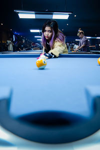 Woman playing pool