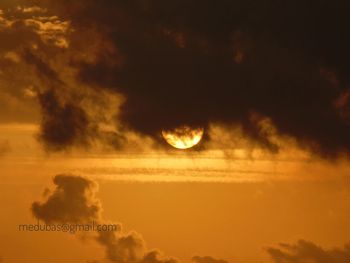Low angle view of silhouette moon against sky at sunset