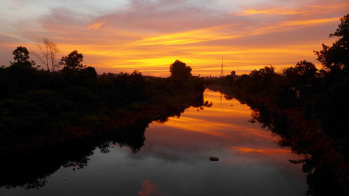 Scenic view of lake against orange sky