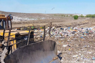 Panoramic shot of garbage on field against sky