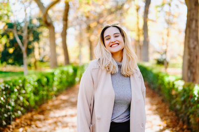 Portrait of a smiling young woman standing outdoors