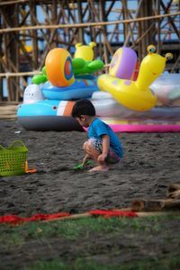 Boy playing with toy on beach