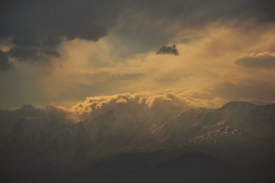 Low angle view of mountain against cloudy sky
