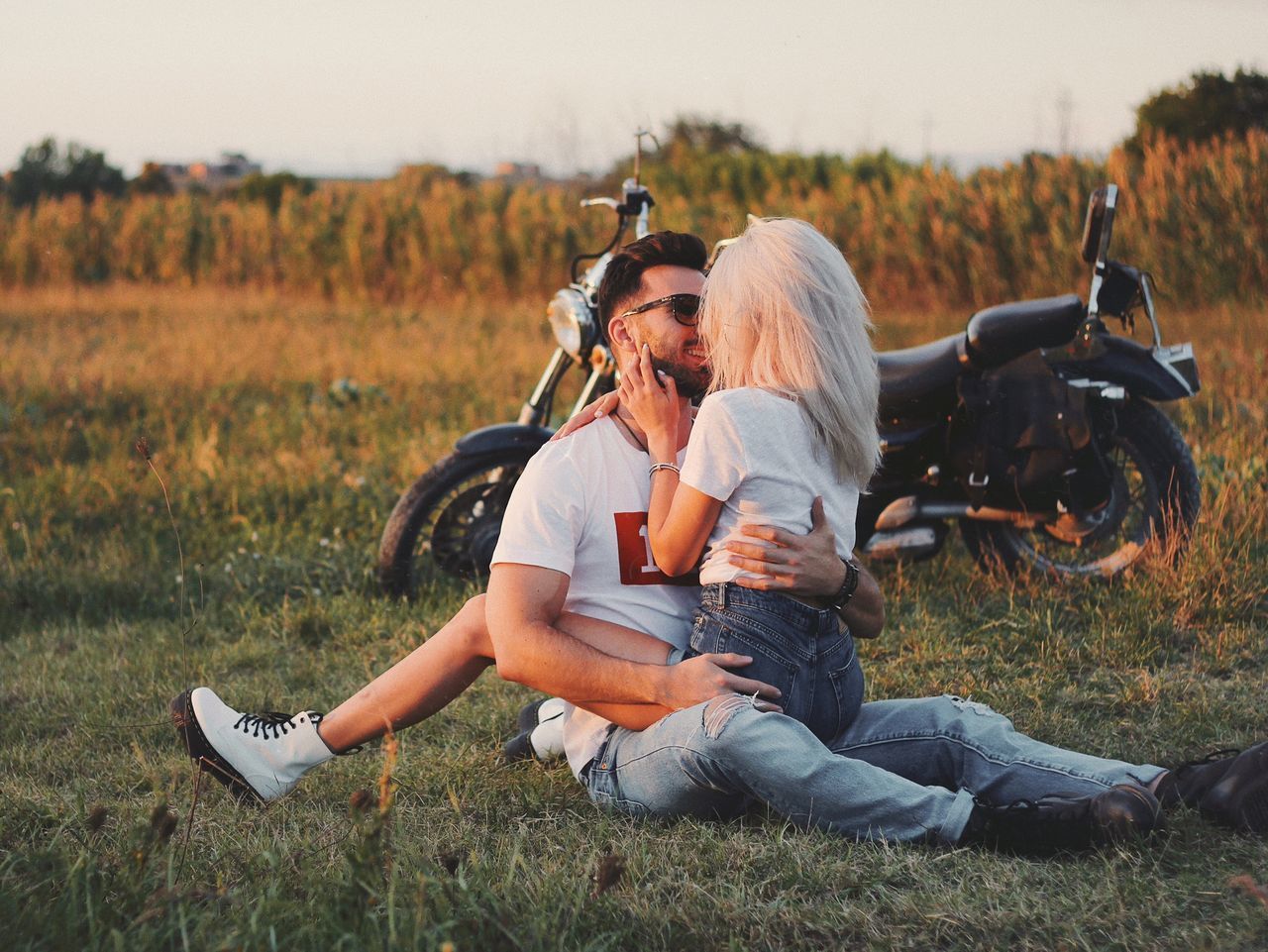 COUPLE SITTING ON LAND