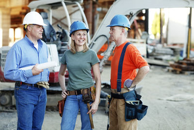 Group of construction workers taking a break standing in front