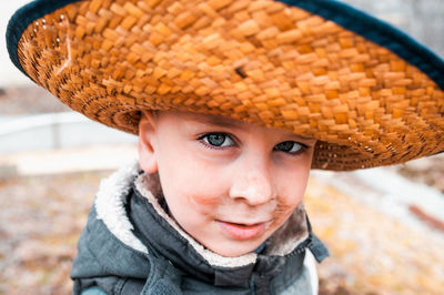  a dirty little cute boy like farmer in straw hat