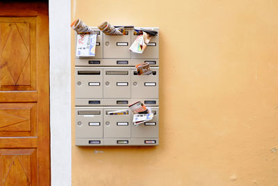 Papers in mail box on wall