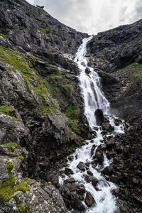 Scenic view of waterfall against sky