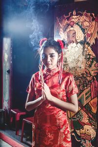 Teenage girl praying at temple