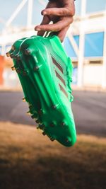 Close-up of hand holding plastic outdoors