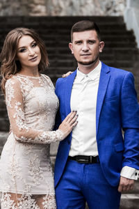 Portrait of young couple standing outdoors