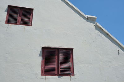 Low angle view of building against blue sky