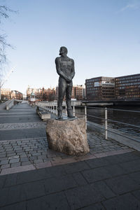 Rear view of man walking on footpath