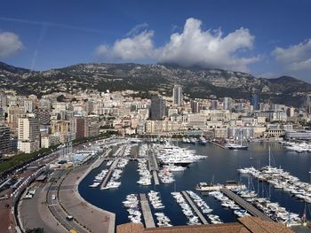 High angle view of city by sea against sky