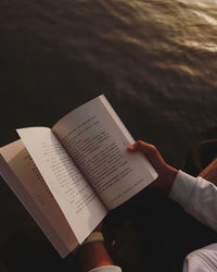 High angle view of hand holding book