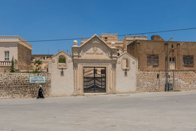 Exterior of buildings against clear blue sky